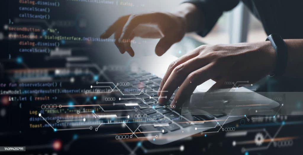 Hands typing on a laptop keyboard with an overlay of programming code and digital network symbols, illustrating the concept of technology and coding as the new era's door-to-door software revolution.
