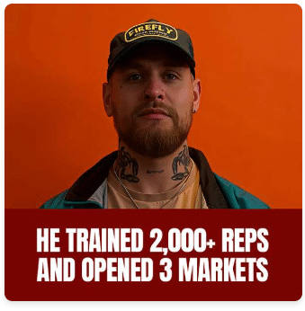A man with a beard and tattoos, wearing a dark cap and jacket, stands in front of an orange background. Text below reads: "He trained 2,000+ reps and opened 3 markets.